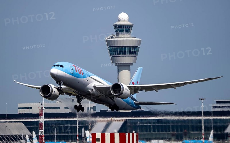 TUI Boeing 787 Dreamliner aircraft taking off at Amsterdam Schiphol Airport, Kaagbaan, 06/24, air traffic control tower, terminal, Netherlands