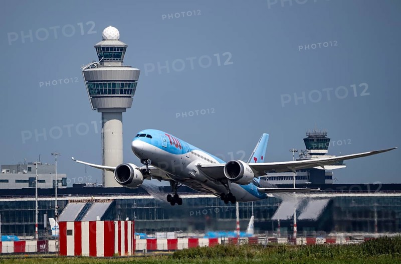TUI Boeing 787 Dreamliner aircraft taking off at Amsterdam Schiphol Airport, Kaagbaan, 06/24, air traffic control tower, terminal, Netherlands