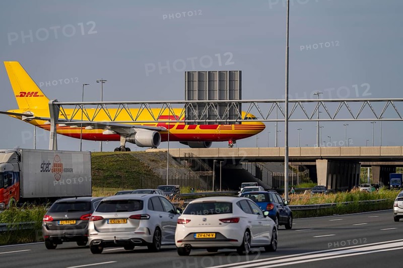Amsterdam Schiphol Airport, DHL Cargo aircraft on the taxiway, bridge over the A4 motorway, connection from the Polderbaan runway to the terminal, Netherlands