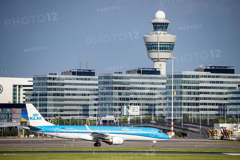 Amsterdam Schiphol Airport, KLM aircraft, Embraer E190STD, on the taxiway, in the background terminal building and air traffic control tower, Netherlands