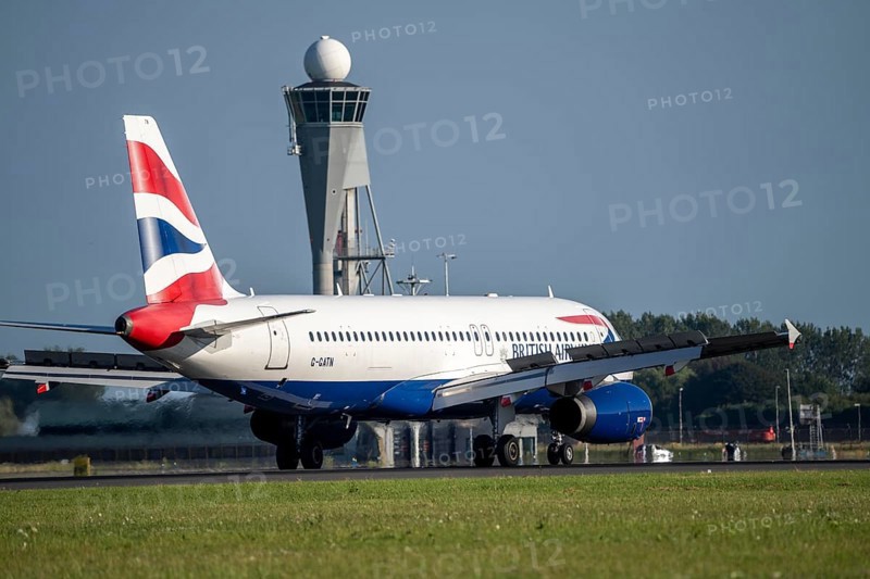 British Airways aircraft after landing at Amsterdam Schiphol Airport, Polderbaan, 18R/36L, taxiway to terminal, Schiphol West control tower and radar tower, Netherlands