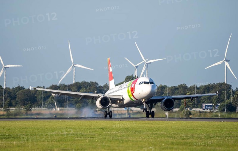 AirPortugal, aircraft landing at Amsterdam Schiphol Airport, Polderbaan, 18R/36L, wind farm in the background, Netherlands