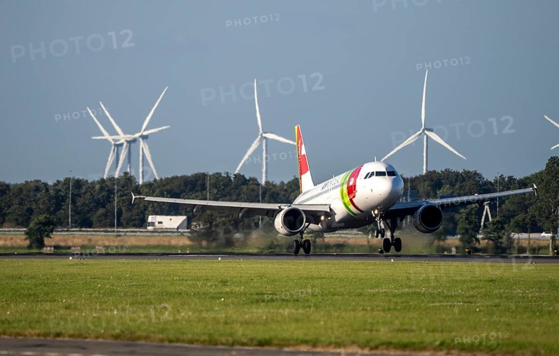 AirPortugal, aircraft landing at Amsterdam Schiphol Airport, Polderbaan, 18R/36L, wind farm in the background, Netherlands