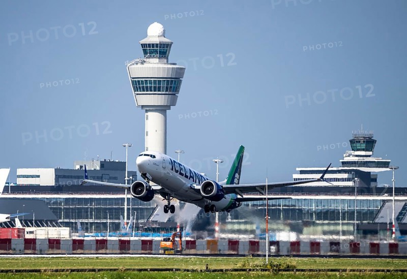 Icelandair aircraft taking off at Amsterdam Schiphol Airport, Kaagbaan, 06/24, air traffic control tower, terminal, Netherlands