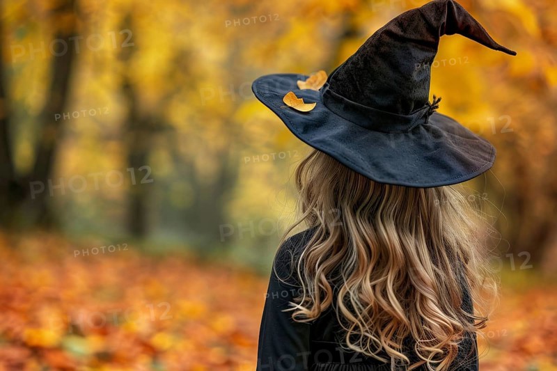 Back view of young girl wearing Halloween witch costume in autumn forest. Generative Ai, AI generated