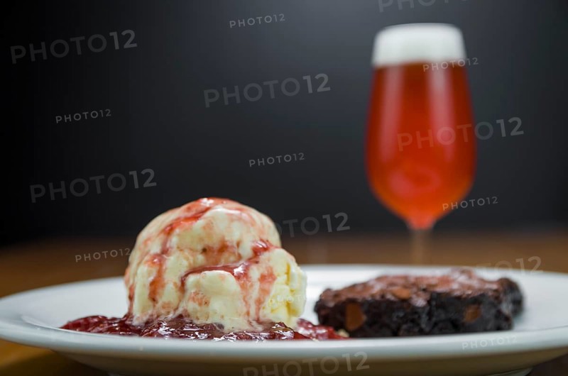 Close-up of delicious chocolade brownie dessert with cream ice cream and raspberry beer