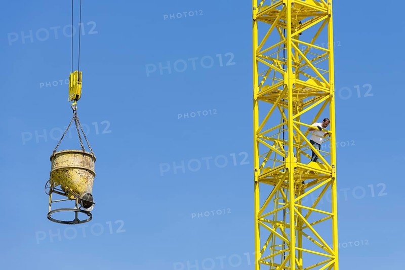 Construction crane with concrete bucket, concrete silo, crane bucket
