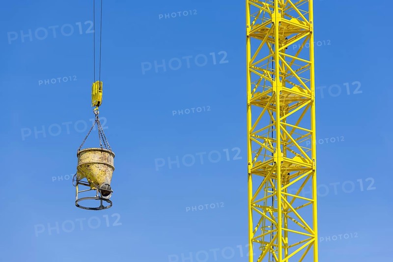 Construction crane with concrete bucket, concrete silo, crane bucket