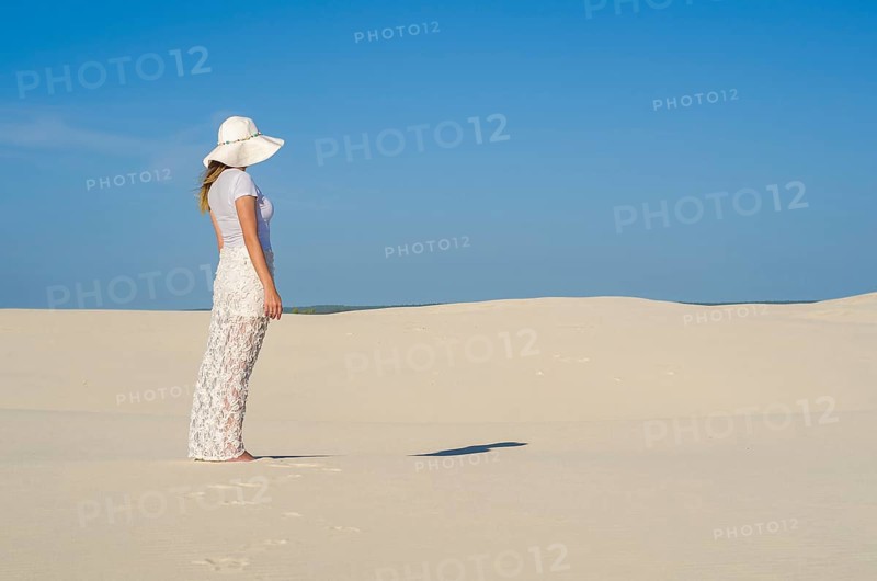 Young woman walking in the dunes, desert