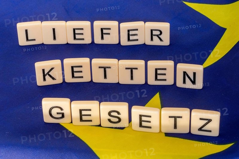 Letters on an EU flag show the word SUPPLY CHAIN LAW