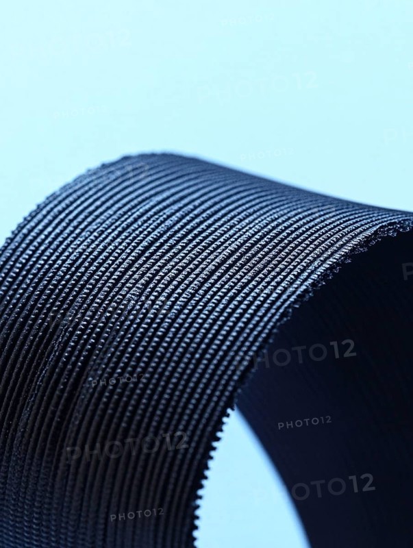 Close-up of a ribbed texture object against a blue background, AI generated