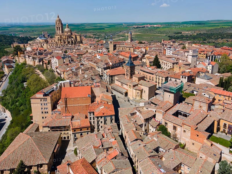 Aerial view of a historic city with large churches surrounded by red tiled roofs and green fields in the hinterland, Aerial view, Cathedral, Segovia, Castilla y Leon, Leon, Spain, Europe