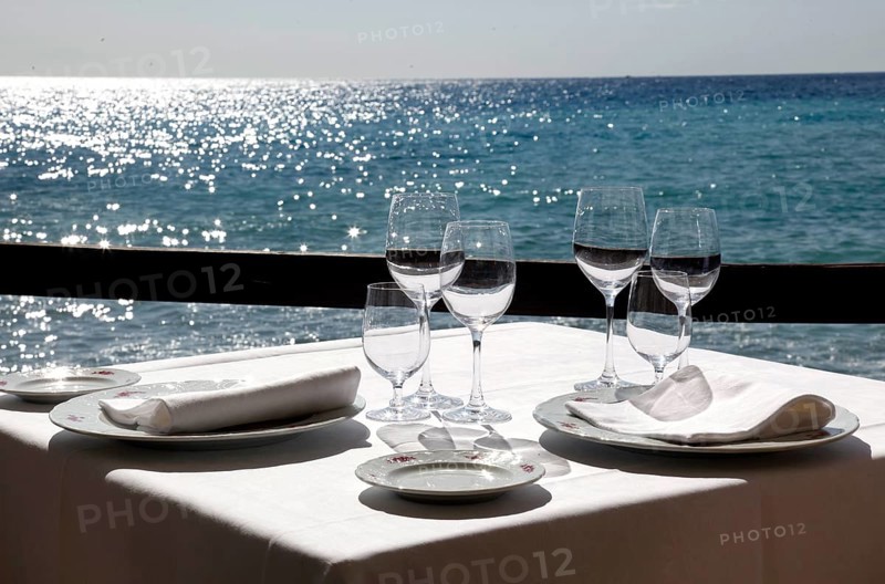 Diano Marina, 13.10.2009, Table set with wine glasses and napkins in a restaurant by the sea, Italy, Europe