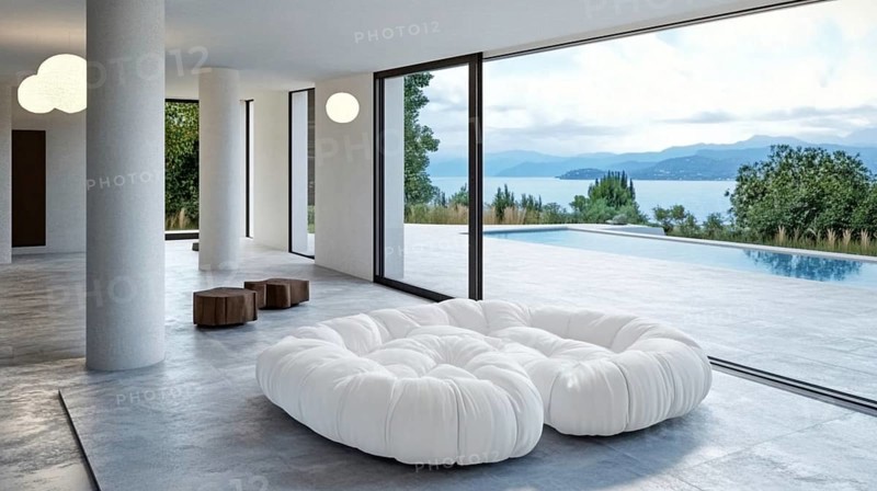 Luxurious modern interior featuring a large white sofa, floor-to-ceiling glass walls with a view of a pool and lake, AI generated