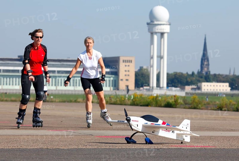 Berlin, 12.10.09 2010, Rollerbladers drive past a model aeroplane on the runway of the former Tempelhof Airport, today Tempelhofer Feld, Berlin, Germany, Europe