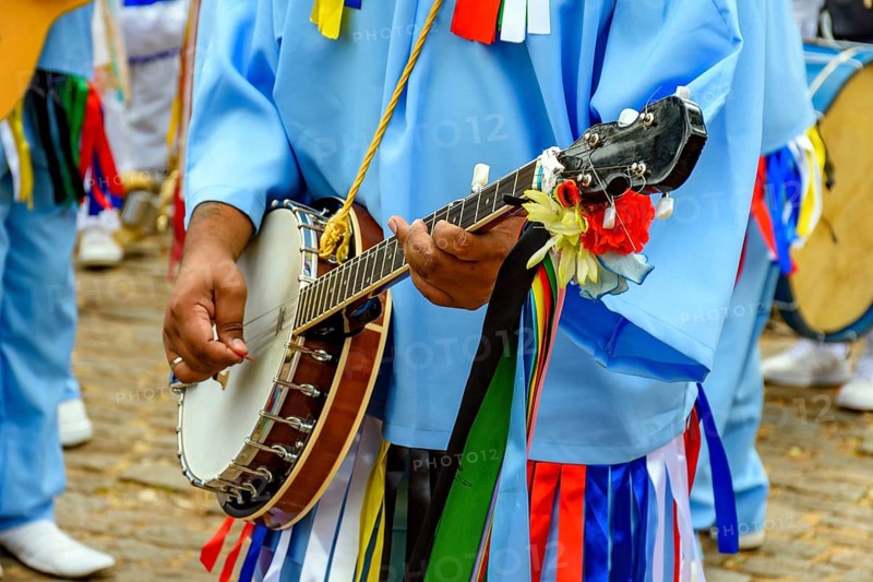 Banjoist on the streets of Brazil wearing colorful clothes during a traditional religious festival, Belo Horizonte, Minas Gerais, Brazil, South America