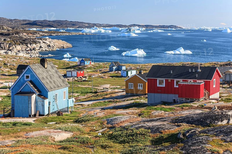 Typical Greenlandic houses, Inuit settlement in front of icebergs, Qeqertaq, Disko Bay, West Greenland, Greenland, North America