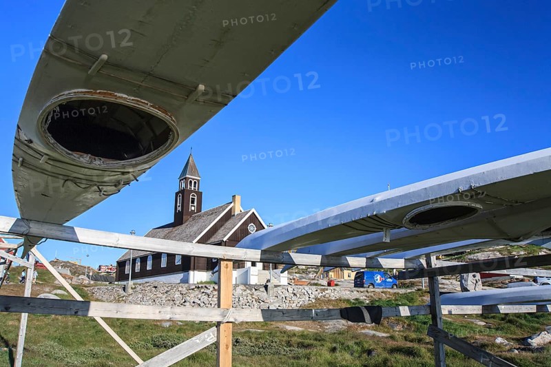 Traditional kayaks on a wooden frame in front of a church, summer, Inuit, Zion's Church, Ilulissat, Ilulissat Icefjord, Disko Bay, West Greenland, Greenland, North America