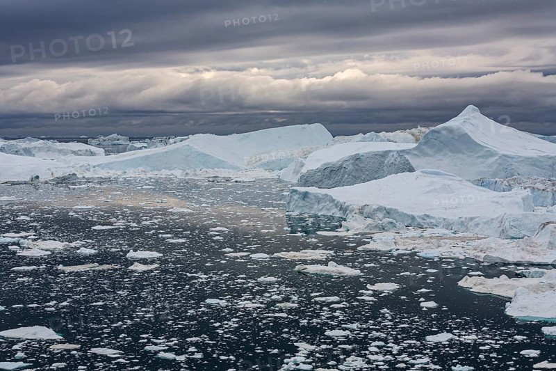 Icebergs in a fjord against a cloudy sky, summer, Ilulissat Icefjord, Disko Bay, West Greenland, Greenland, North America