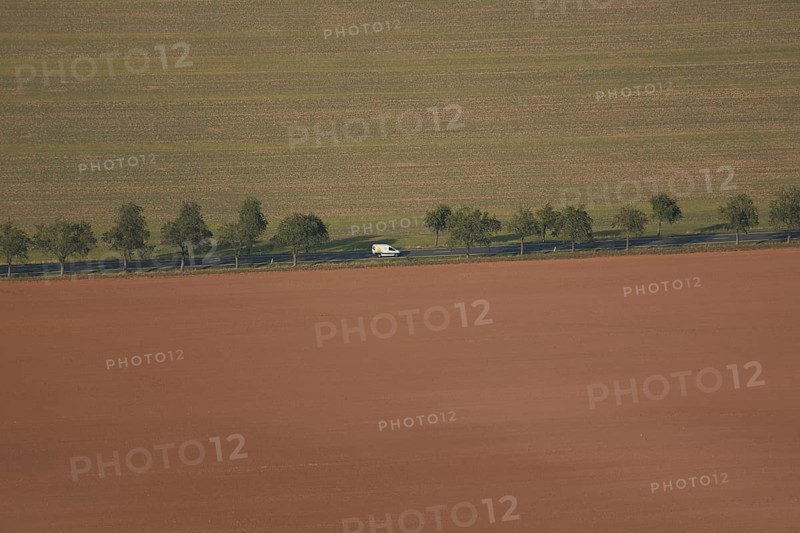 View from Kyffhäuser monument to straight road with avenue and white car, view from above, fields, acre, structure, divided, half, straight, line, one, solitary, bright, shine, valley, travelling, drive, Kyffhäuser, Thuringia, Germany, Europe