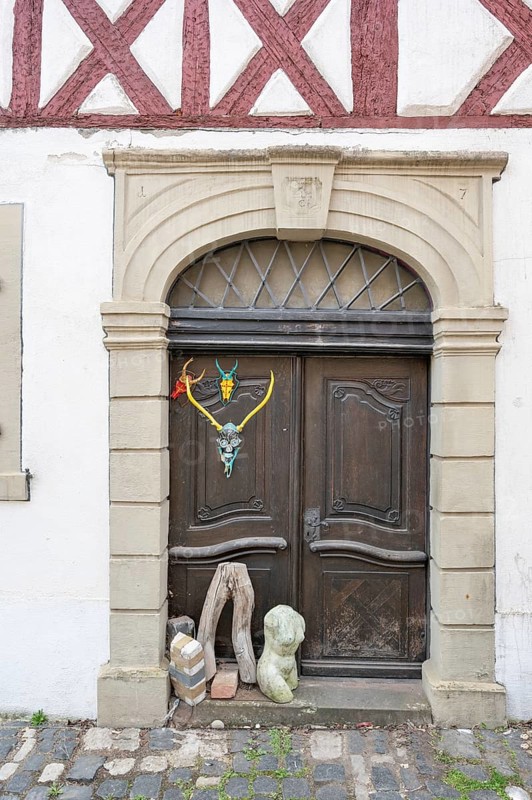 Art objects in front of a historic entrance gate, Mainbernheim, Lower Franconia, Bavaria, Germany, Europe