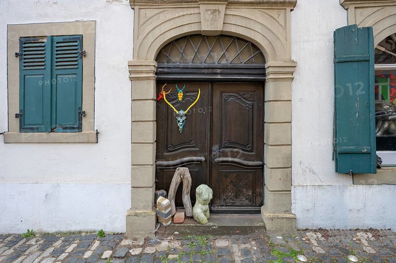 Art objects in front of a historic entrance gate, Mainbernheim, Lower Franconia, Bavaria, Germany, Europe