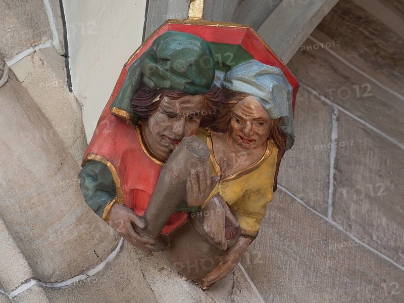 Man with beer glass and woman with money, console figures in Heilig Kreuz Minster, Rottweil, Baden-Württemberg, Germany, Europe