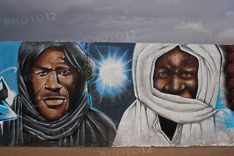 Mural painting depicting Ibrahima Fall (left) and Amadou Bamba (right), two sufi masters and muslim religious leaders highly revered in Senegal (Thiès, Senegal) . Bamba is the founder of the Mouride brotherhood