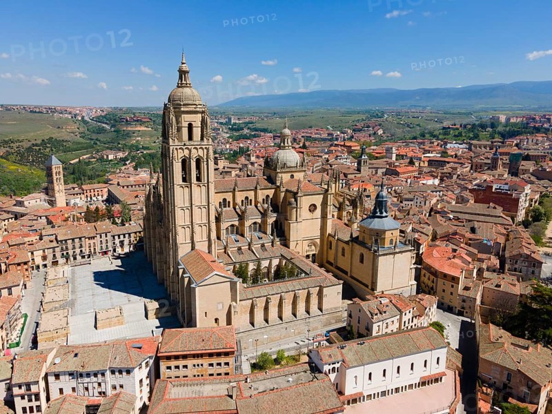 Large church in a medieval town, surrounded by red roofs and historic buildings, under a blue sky and in a green landscape, aerial view, Cathedral, Segovia, Castilla y Leon, Leon, Spain, Europe