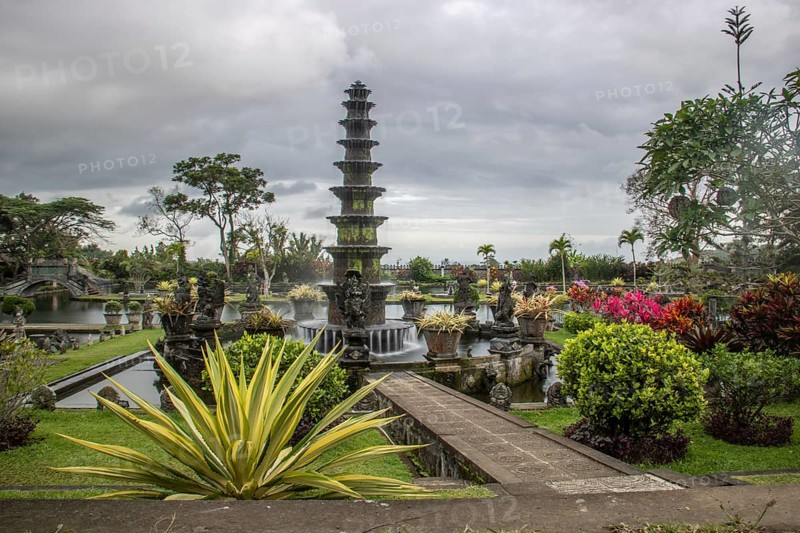 The water temple or water palace of the king. Tropical landscapes, colourful flowers and statues can be found at the Tirta Gangga site, Bali, Indonesia, Asia