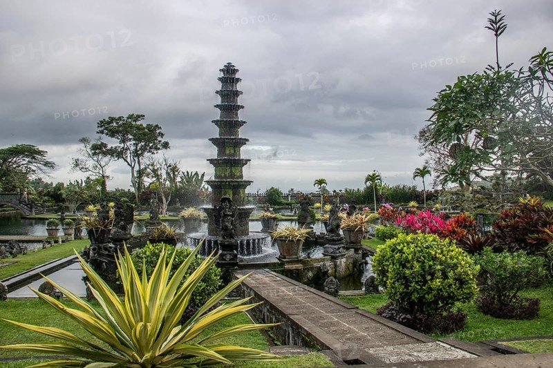 The water temple or water palace of the king. Tropical landscapes, colourful flowers and statues can be found at the Tirta Gangga site, Bali, Indonesia, Asia