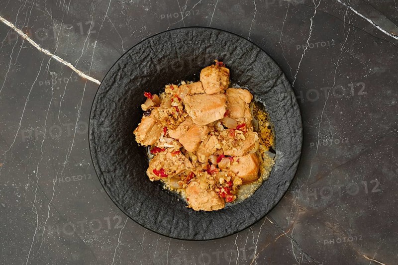 Overhead view of portion of chicken fillet ragout with walnuts