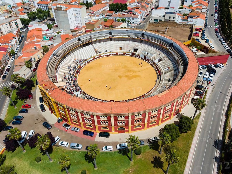 Historic bullring in a city, surrounded by buildings and green landscape, with cars and trees outside, taken in sunshine, aerial view, bullfight, Merida, Badajoz, Extremadura, Spain, Europe