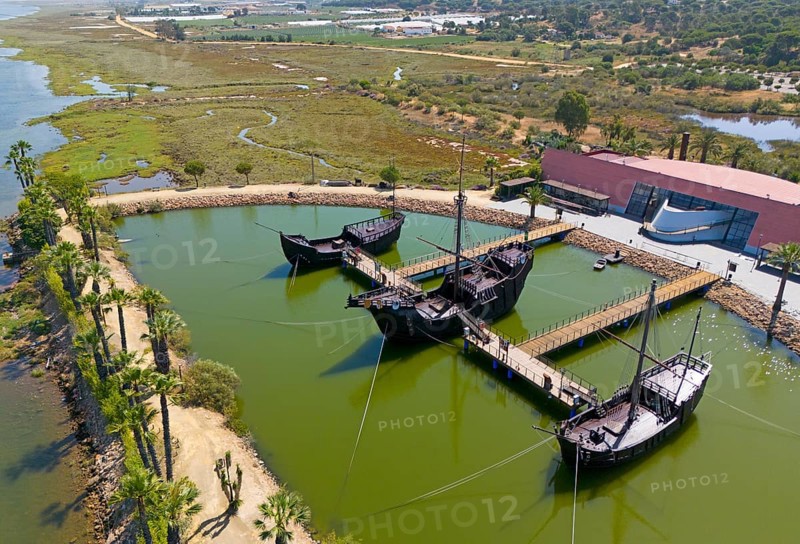 Historically modelled sailing ships in a calm water basin, surrounded by landscape under a clear sky, aerial view, Muelle de las Carabelas, reproductions of La Nina, La Pinta and La Santa Maria, Museum, Palos de la Frontera, Province of Huelva, Andalusia, Spain, Europe