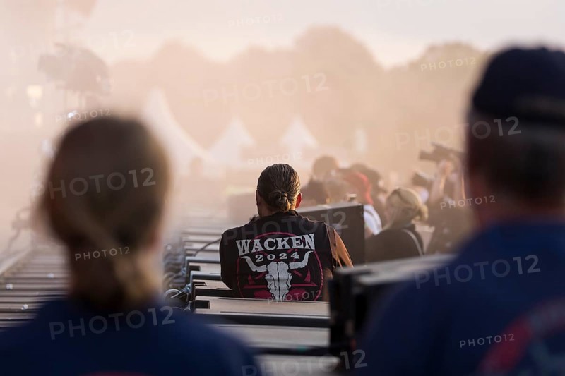 Employees with Wacken waistcoat in the stage pit at the Wacken Open Air in Wacken. The traditional metal festival takes place from 31 July to 3 August 2024