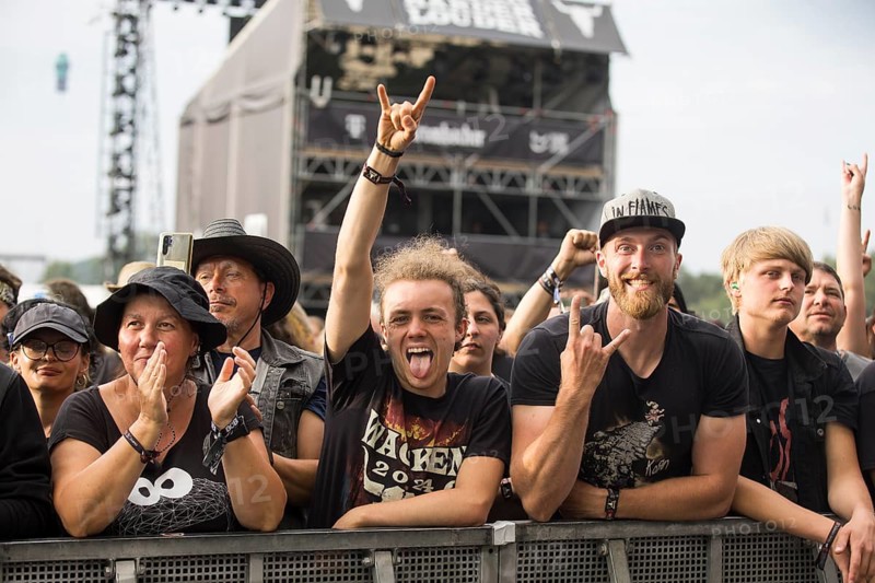 Festival visitors give the devil's salute at the Wacken Open Air in Wacken. The traditional metal festival takes place from 31 July to 3 August 2024