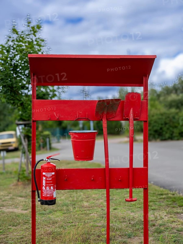 Red fire extinguishing point with fire extinguisher, shovel, spade and bucket at a campsite on Lake Jersleben, Jersleben, Saxony-Anhalt, Germany, Europe