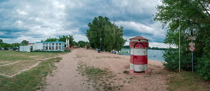 Old round red and white striped changing room from GDR times in the shape of a lighthouse on the shore of Lake Jersleben next to a campsite, Jersleben, Saxony-Anhalt, Germany, Europe