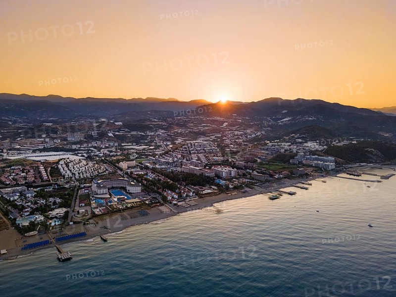 The sun rises behind the mountains of the Taurus Mountains on the Turkish Riviera. (Aerial view with a drone), Konakli, Alanya, Antalya, Turkey, Asia