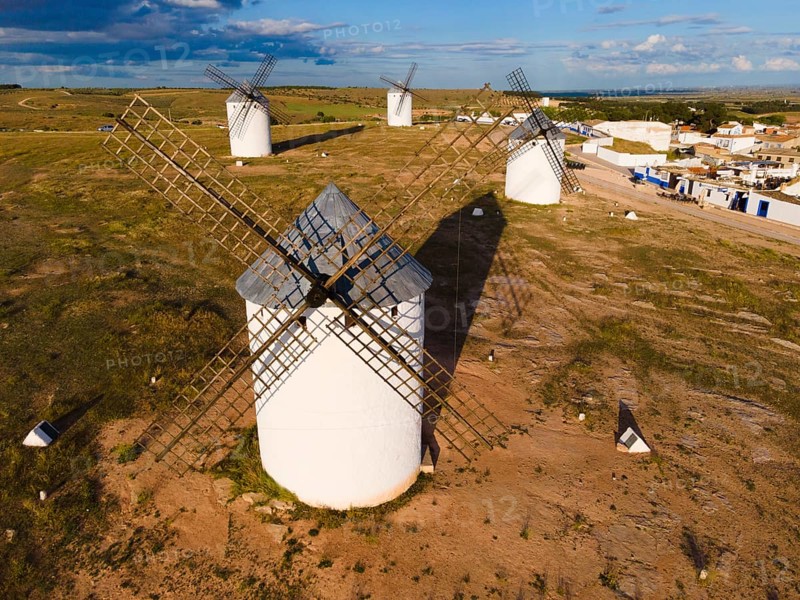 Close-up of several windmills in a green landscape under a blue sky with clouds, aerial view, windmills, Campo de Criptana, Ciudad Real province, Castilla-La Mancha, Route of Don Quixote, Spain, Europe