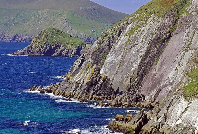 Breathtaking cliff landscape, coloured in green and grey, lined with deep blue sea and green hills, Tourism, Slea Head Drive, Dingle, Ireland, Europe