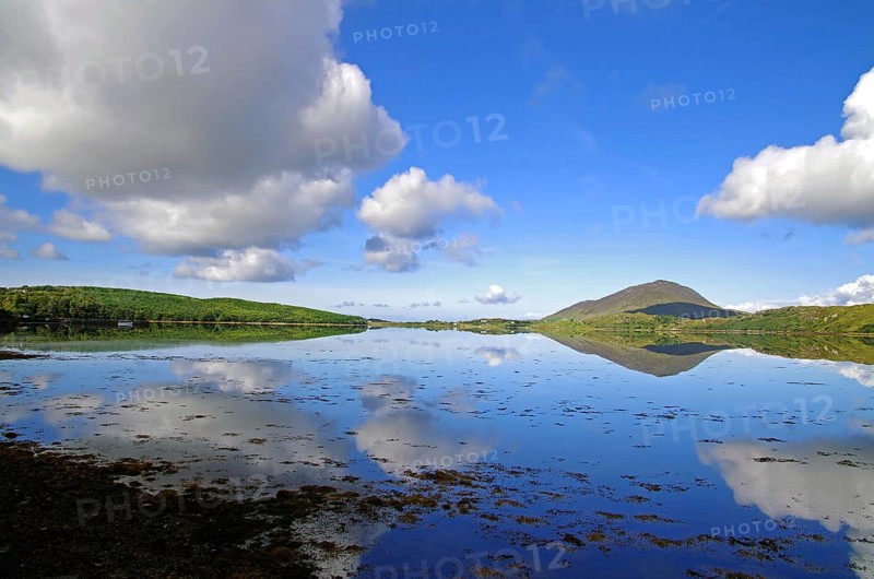 Calm lake with cloud reflections and mountain hills in the background, Letterfrack, Connemara National Park, Ireland, Europe