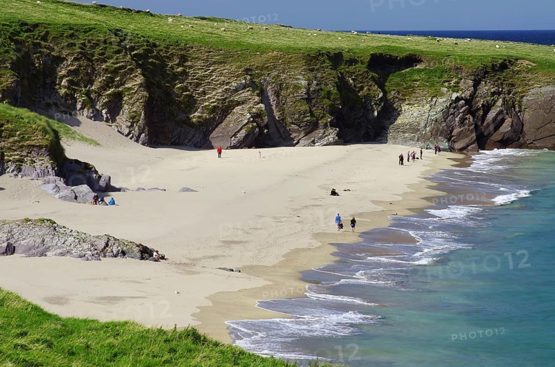 Sandy beach beach with cliffs in the background and people along the coast, Blasket Islands, Dunmore Head, Ireland, Europe