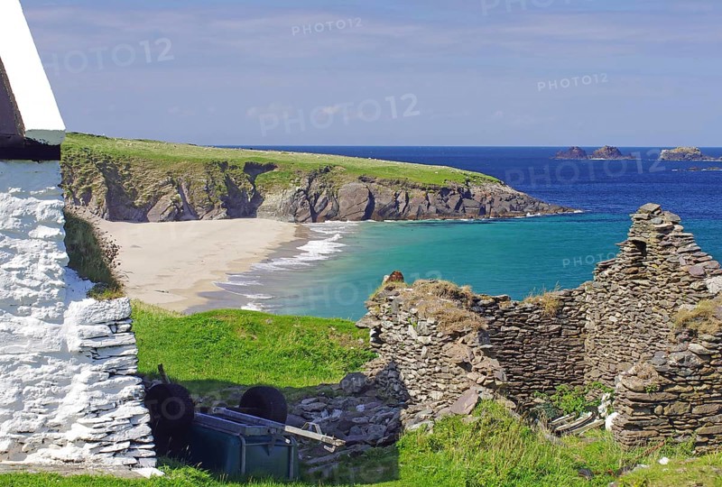 Stone ruins and farmhouse on a rocky coast with sandy beach, Blasket Islands, Dunmore Head, Ireland, Europe