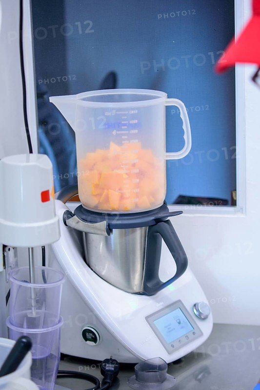 A modern blender being used to chop and measure fruits in a kitchen