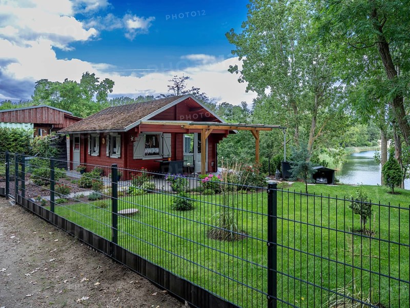 Fenced wooden holiday home with lawn on Lake Jersleben, Jersleben, Saxony-Anhalt, Germany, Europe