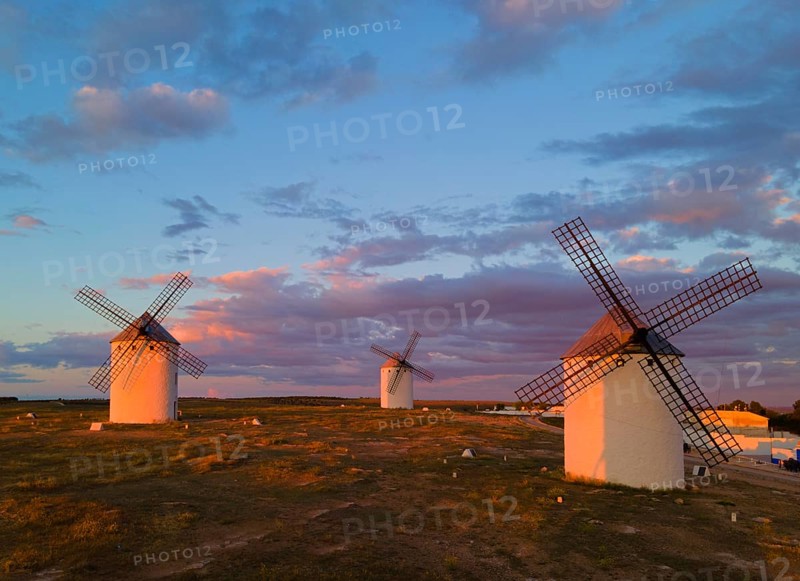 Three windmills stand on a vast landscape under a pink and blue sky during sunset, aerial view, windmills, Campo de Criptana, Ciudad Real province, Castilla-La Mancha, Route of Don Quixote, Spain, Europe