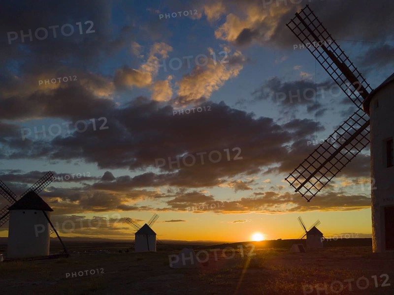 Sunset with silhouettes of windmills against a colourful sky with dramatic clouds, windmills, Campo de Criptana, Ciudad Real province, Castilla-La Mancha, Route of Don Quixote, Spain, Europe