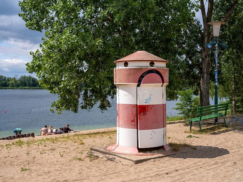 Old round red-white-ringed changing room from GDR times in the shape of a lighthouse on the shore of Lake Jersleben next to a campsite, Jersleben, Saxony-Anhalt, Germany, Europe