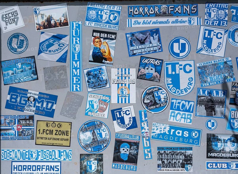 Stickers of Ultras, horror fans, hardcore fans of the football club 1. FC Magdeburg on a board at the Jersleber See, Jersleben, Saxony-Anhalt, Germany, Europe